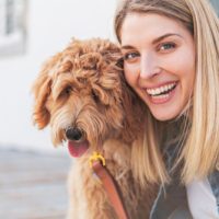 goldendoodle with woman puppies