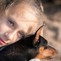 Caucasian,Teenage,Girl,With,Big,Blue,Eyes,Hugs,Mini,Pinscher